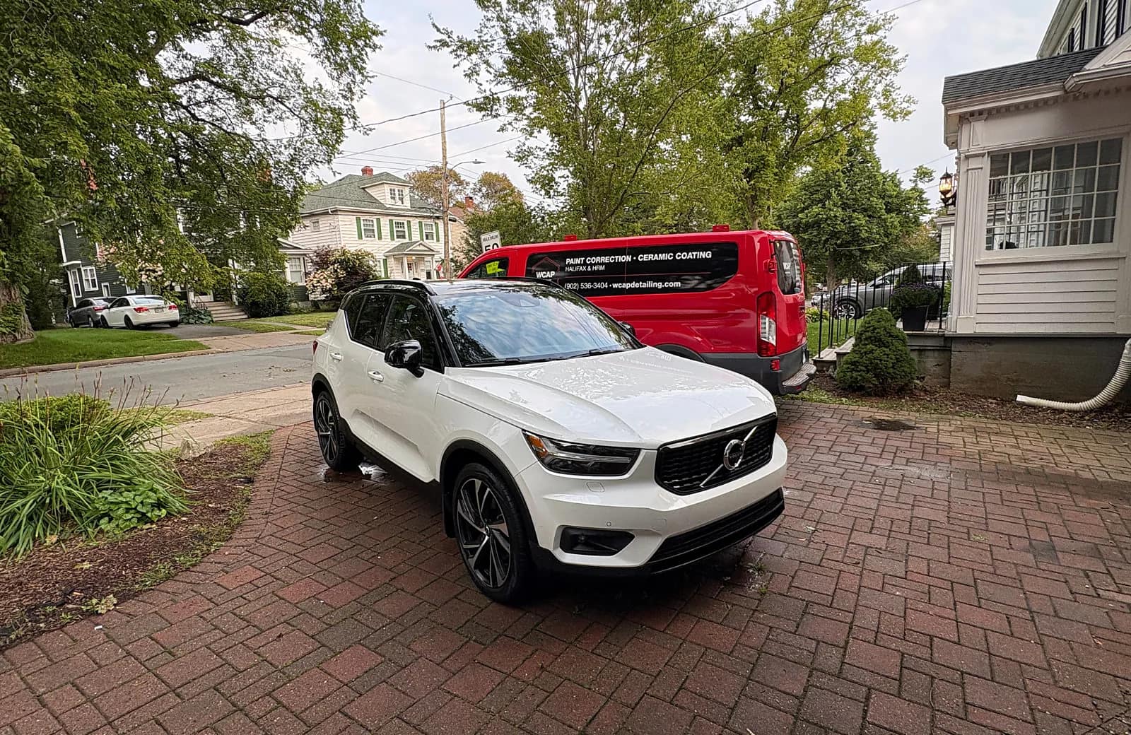 White Volvo after WCAP Detailing mobile service with the WCAP Detailing van at a Halifax-area driveway